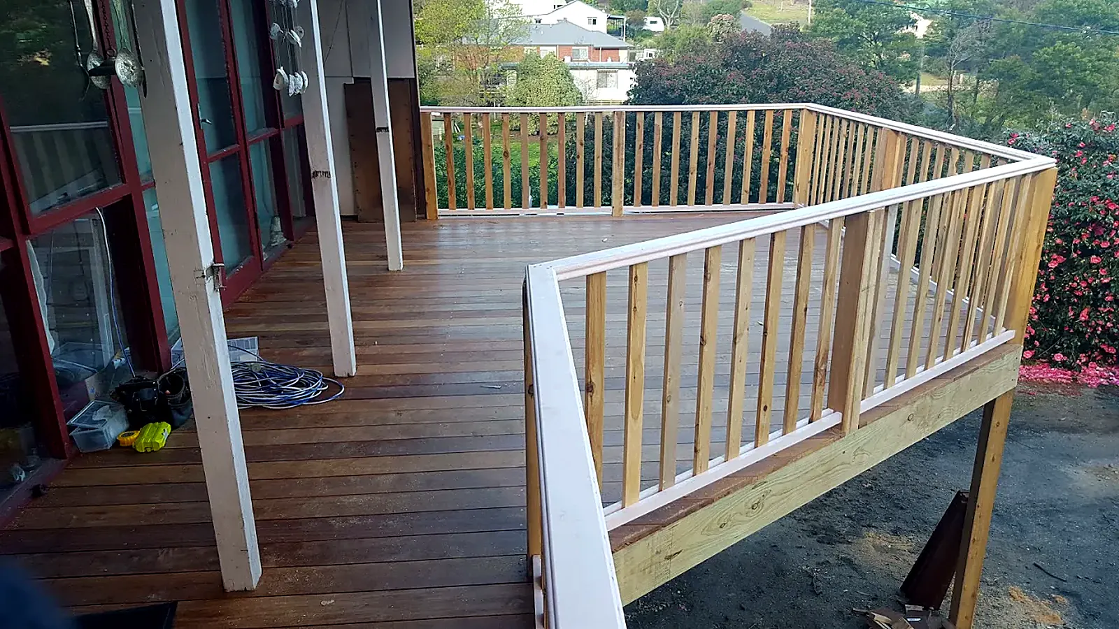 Elevated balcony deck with new timber railings overlooking a garden