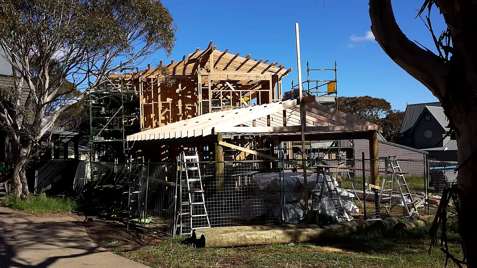 Timber frame of a new home under construction with scaffolding, East Gippsland