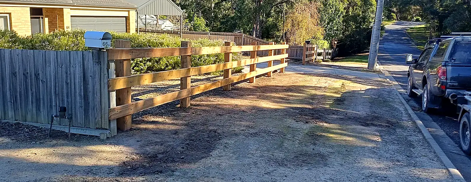 New post-and-rail timber fence along a roadside boundary